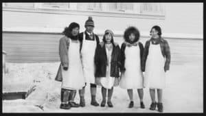 Photo depicting changing fashion in the 1920s at White Mountain, Alaska, Mendadelook, p. 88, used with permission.
